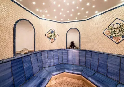 a swimming pool in a room with blue tiles at Wellness Residence Villa Leck in Selva di Val Gardena