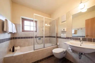a bathroom with a sink toilet and a shower at Hotel Seerast in Ultimo