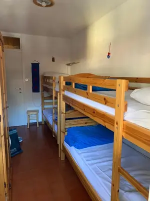 a room with three bunk beds in a room at Casa Lulu' in Predazzo