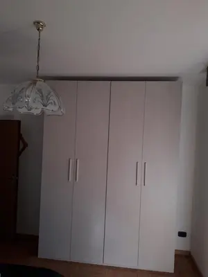 a white cabinet in a room with a ceiling at Appartamento Vista Dolomiti by GoNewLocation in Moena