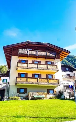 a building with balconies on the side of it at Appartamento Vista Dolomiti by GoNewLocation in Moena