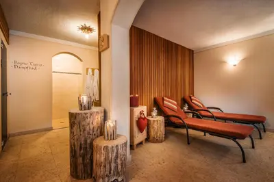 a living room with a couch and a table with a lamp at Residence Ciasa Planat in San Cassiano
