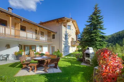 a living room with a couch and a table at Residence Ciasa Planat in San Cassiano