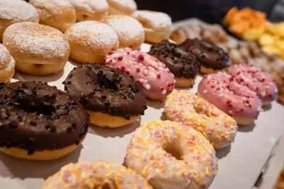 a bunch of different types of donuts on a table at Hotel Hell in Ortisei
