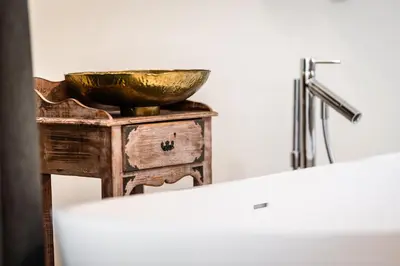 a bowl on top of a table with a sink at Hotel Hell in Ortisei