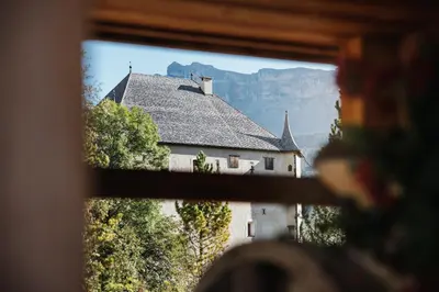 a large wooden building with flowers in the window at Apartment Sotmarin in La Villa
