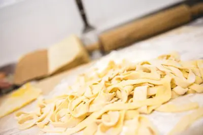 a pile of pasta on a cutting board at Albergo Vezzana in Passo Rolle
