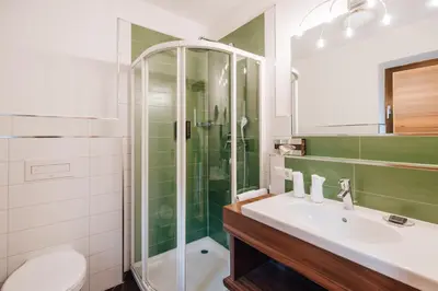a bathroom with a sink and a shower at Apartments Bachmair in Schenna