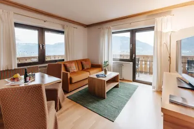 a living room with a couch and a table at Apartments Bachmair in Schenna