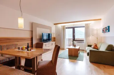 a living room with a table and a couch at Apartments Bachmair in Schenna