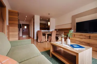 a living room with a couch and a table with a television at Apartments Bachmair in Schenna
