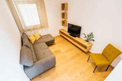 a living room with a couch and a television at Egarter in Appiano sulla Strada del Vino
