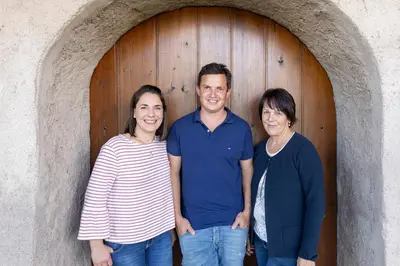 a man and two women standing in front of a door at Egarter in Appiano sulla Strada del Vino