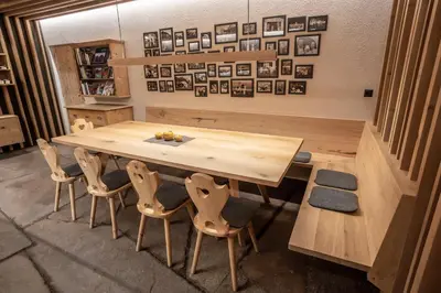 a large wooden table and chairs in a room at Egarter in Appiano sulla Strada del Vino