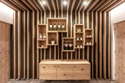 a room with a shelf with bottles of wine at Egarter in Appiano sulla Strada del Vino