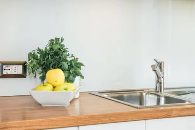 a bowl of fruit on a counter next to a sink at Amonit - Your Dolomites Home in Selva di Val Gardena