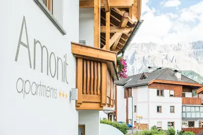 a balcony on the side of a building at Amonit - Your Dolomites Home in Selva di Val Gardena