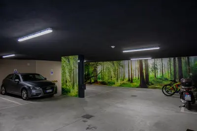 a parking garage with a car parked in it at Residence Villa Hedy in Merano
