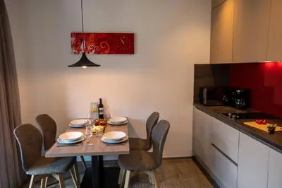 a small kitchen with a table and chairs in a room at Residence Villa Hedy in Merano
