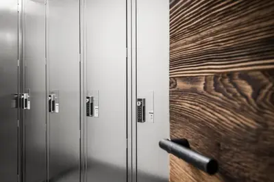 a row of metal lockers with a wooden wall at Chalet Roenn in Colfosco