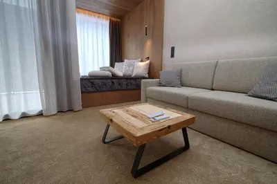 a living room with a couch and a coffee table at Bonfanti Design Hotel in Chienes