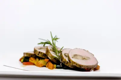 a plate of food with meat and vegetables on it at Albergo Eden in Fiera di Primiero