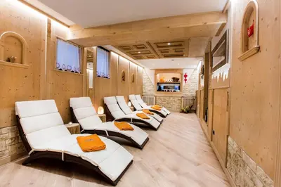 a row of white chairs in a room at Albergo Eden in Fiera di Primiero
