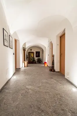 an empty hallway with white walls and a white ceiling at Gasthof Zur Sonne in Laion