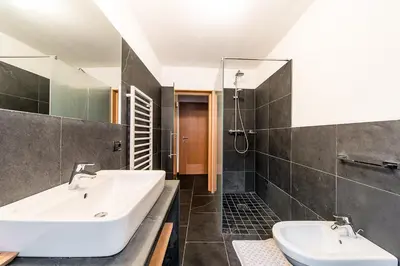 a bathroom with a white sink and a shower at Gasthof Zur Sonne in Laion