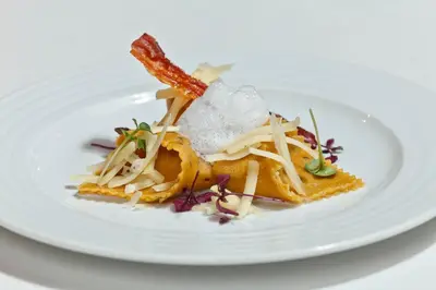 a plate of food on a white plate at Vitalhotel Rainer in Ultimo