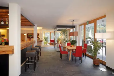 a dining room with a table and chairs at Vitalhotel Rainer in Ultimo