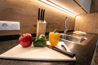 a cutting board with peppers and a knife and fork at Chalet Morin in San Martino in Badia