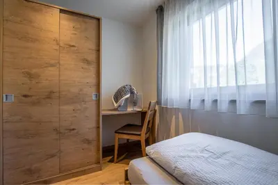 a bedroom with a bed and a window and a desk at Chalet Morin in San Martino in Badia
