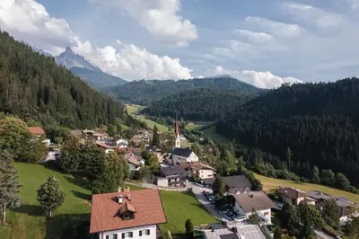 an aerial view of a village in the mountains at Apartments Kranebitt in Eggen