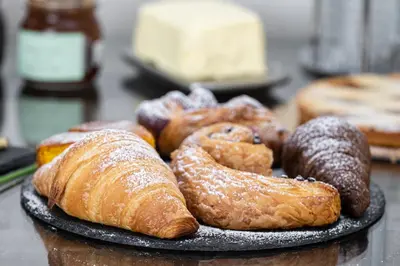 a plate of different types of pastries on a table at Piccolo Orso Bruno in Cavareno