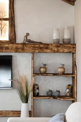 a wooden shelf with bowls and vases on a wall at Piccolo Orso Bruno in Cavareno
