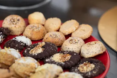 a red plate filled with different types of donuts at Piccolo Orso Bruno in Cavareno