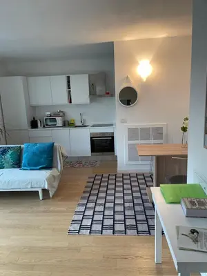 a living room with a couch and a table at Appartamento Ligeia in Bolzano
