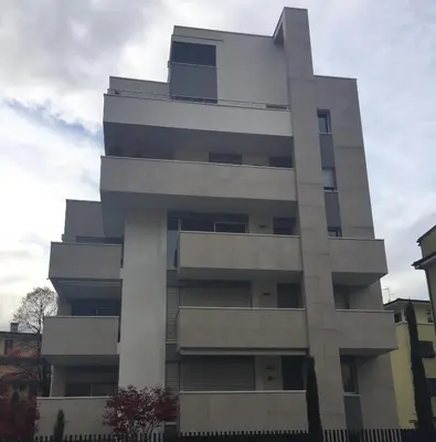 a tall white building with a sky in the background at Appartamento Ligeia in Bolzano