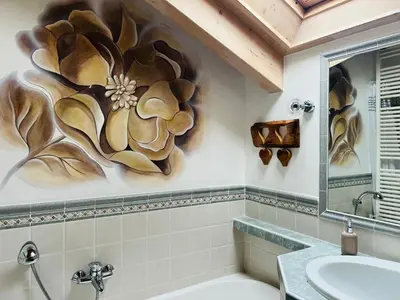 a bathroom with a sink and a mirror and a toilet at Casanemone in Tesero