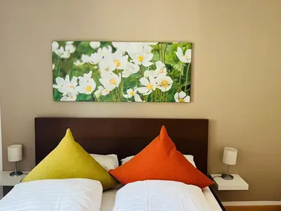 a bathroom with a painting of a flower on the wall at Casanemone in Tesero