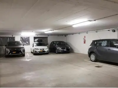 a parking garage with three cars parked in it at Haus Hofer *** in Andrian