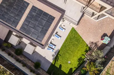 an overhead view of a building with a lawn at Garni Hotel Sonnleitenhof in Caldaro