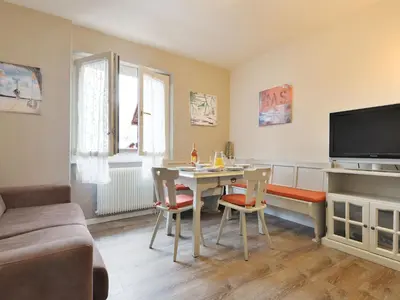 a living room with a table and a tv at Apartment Apt 20 by Interhome in Alba di Canazei