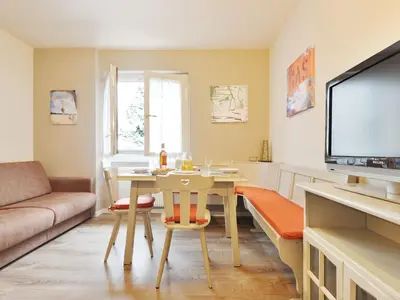 a kitchen and living room with a table and chairs at Apartment Apt 20 by Interhome in Alba di Canazei