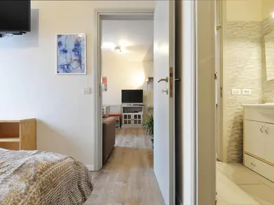 a bedroom with a large bed and a bathroom at Apartment Apt 20 by Interhome in Alba di Canazei