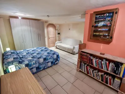 a bedroom with a bed and a couch in a room at Apartment La Busa-4 by Interhome in Alleghe