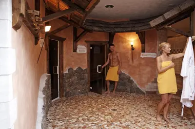 a man and a woman standing in a room at Landhotel Tharerwirt in Valdaora