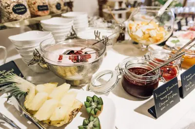 a table topped with bowls of food and desserts at Amplatz 1523 - B&B and Suites in Montagna