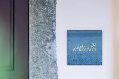 a blue book on a wall with the words everyday werentatch at Amplatz 1523 - B&B and Suites in Montagna